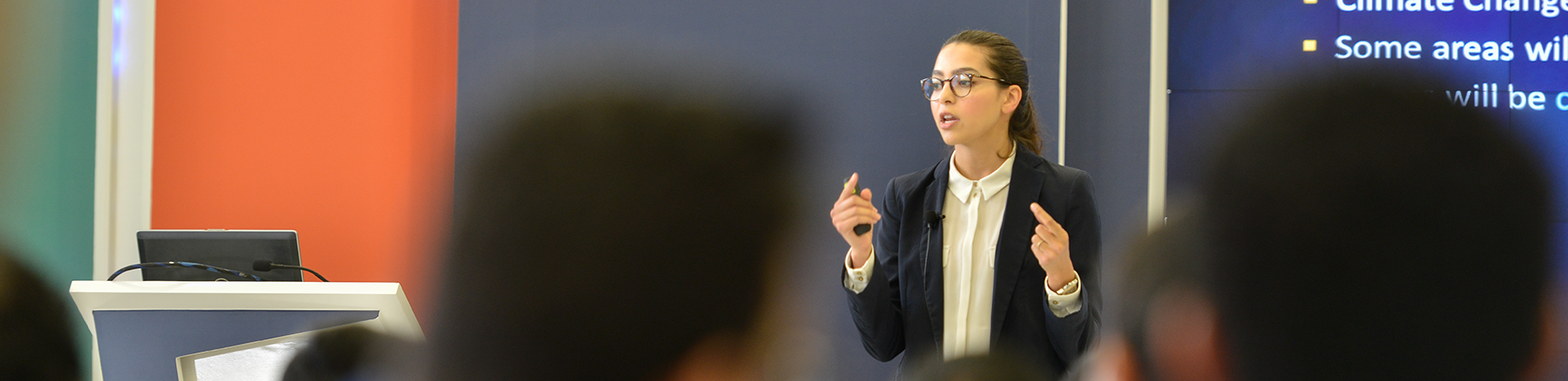 Young female Saudi Aramco employee presents at the Upstream Professional Development Center