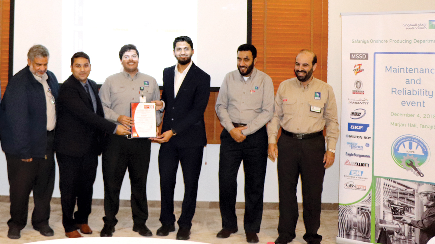 Attendees receiving certificate at ceremony.